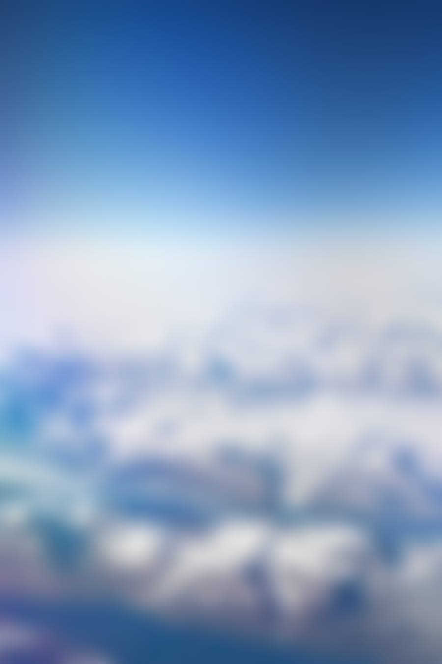 Blurred preview of Greenland's ice and mountains seen from a plane